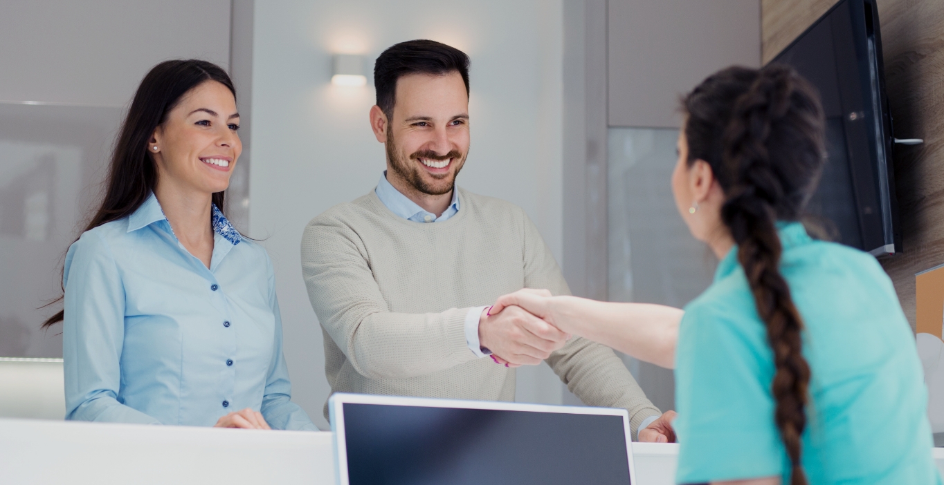 couple talking with front desk